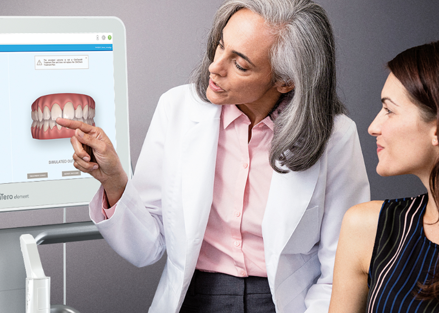 Dentist discussing itero scans with patient